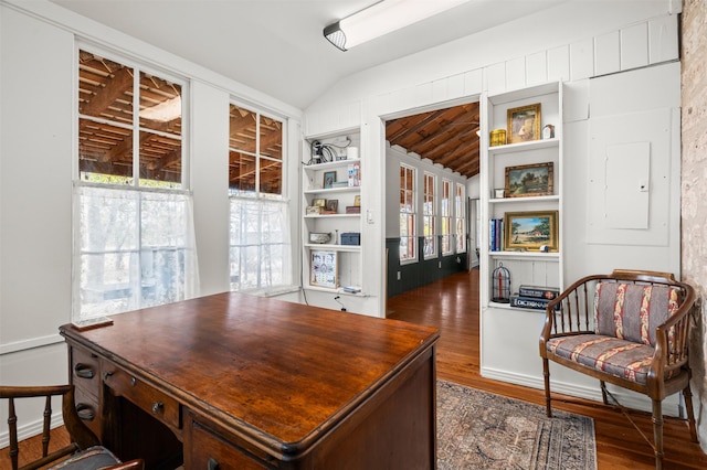 office space with lofted ceiling and dark wood-type flooring