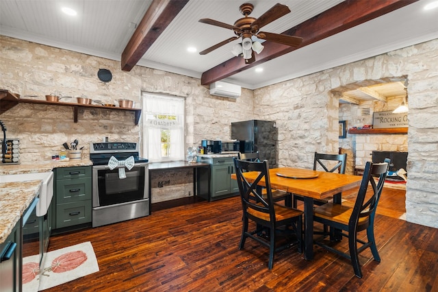 kitchen featuring a wall unit AC, stainless steel range with electric stovetop, green cabinets, and beam ceiling