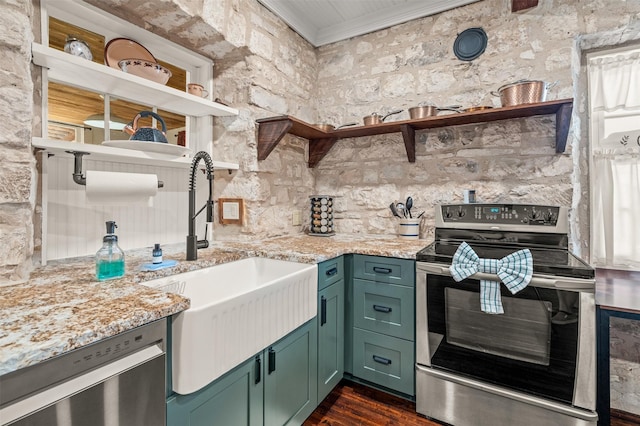 kitchen with appliances with stainless steel finishes, a sink, open shelves, and light stone countertops