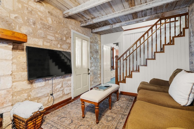 living area with wood finished floors, wooden ceiling, beam ceiling, and stairs