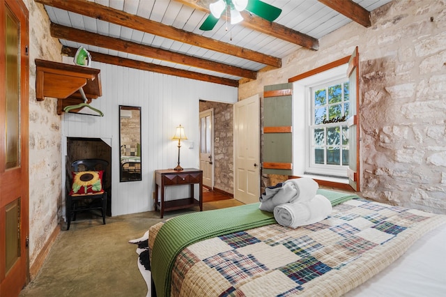 bedroom featuring a fireplace and beam ceiling