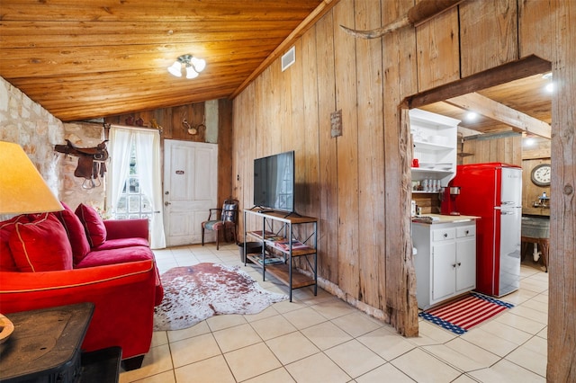 living area with light tile patterned floors, wooden walls, visible vents, wooden ceiling, and vaulted ceiling