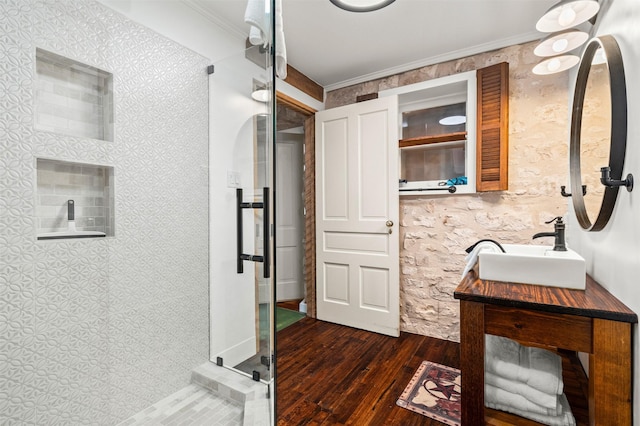 full bath with ornamental molding, a stall shower, wood finished floors, and vanity