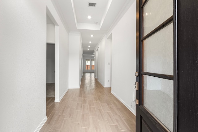 corridor with crown molding, recessed lighting, visible vents, light wood-style floors, and baseboards