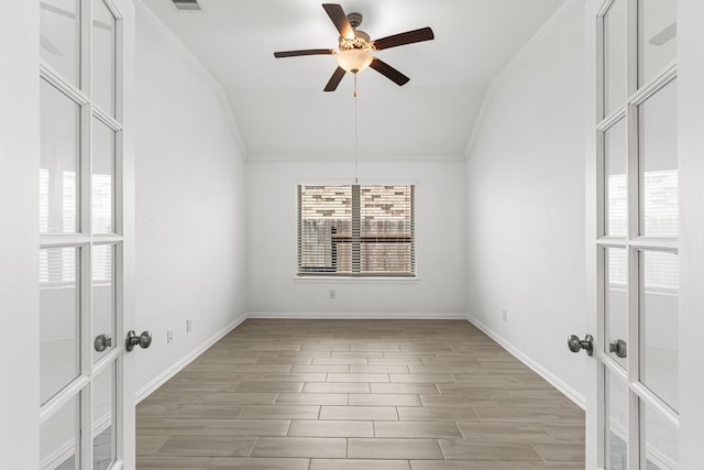 unfurnished room with baseboards, ceiling fan, ornamental molding, wood tiled floor, and vaulted ceiling