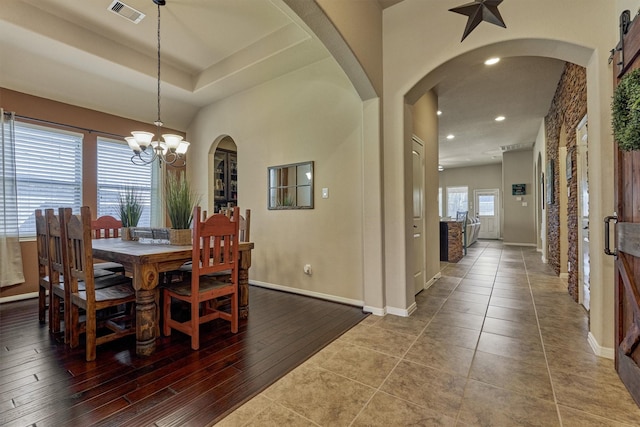 dining area featuring visible vents, a chandelier, arched walkways, and recessed lighting