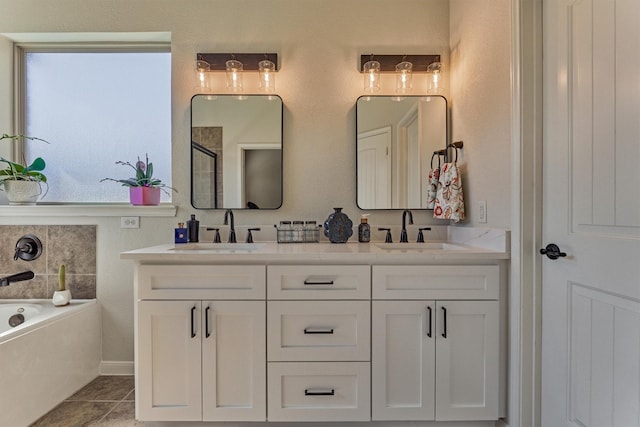 full bathroom with double vanity, tile patterned flooring, and a sink