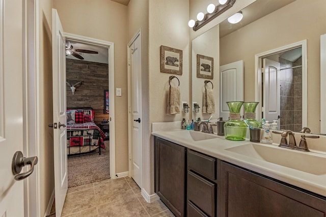 full bath with tile patterned floors, a sink, ensuite bath, and double vanity