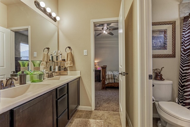 ensuite bathroom featuring toilet, ensuite bath, double vanity, and a sink