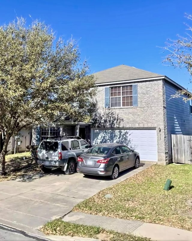 view of front facade with a garage, brick siding, and driveway