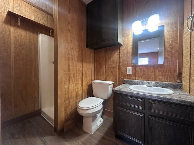 bathroom featuring vanity, toilet, and wood finished floors