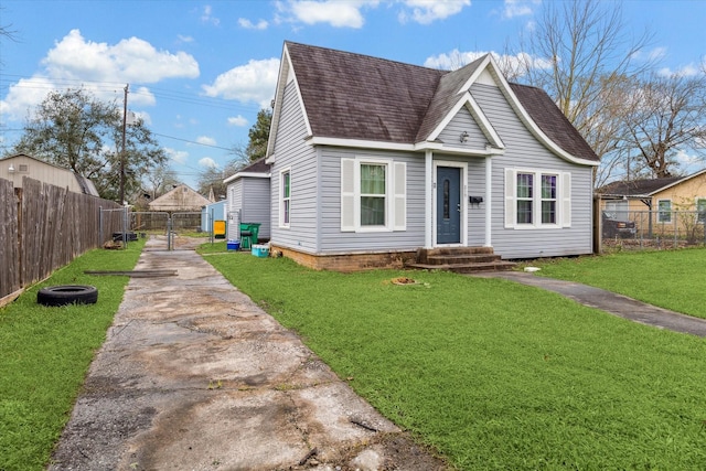 view of front of property with a gate, a front yard, fence, and roof with shingles