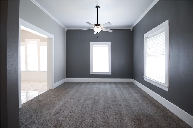 unfurnished room with ornamental molding, carpet flooring, baseboards, and a ceiling fan