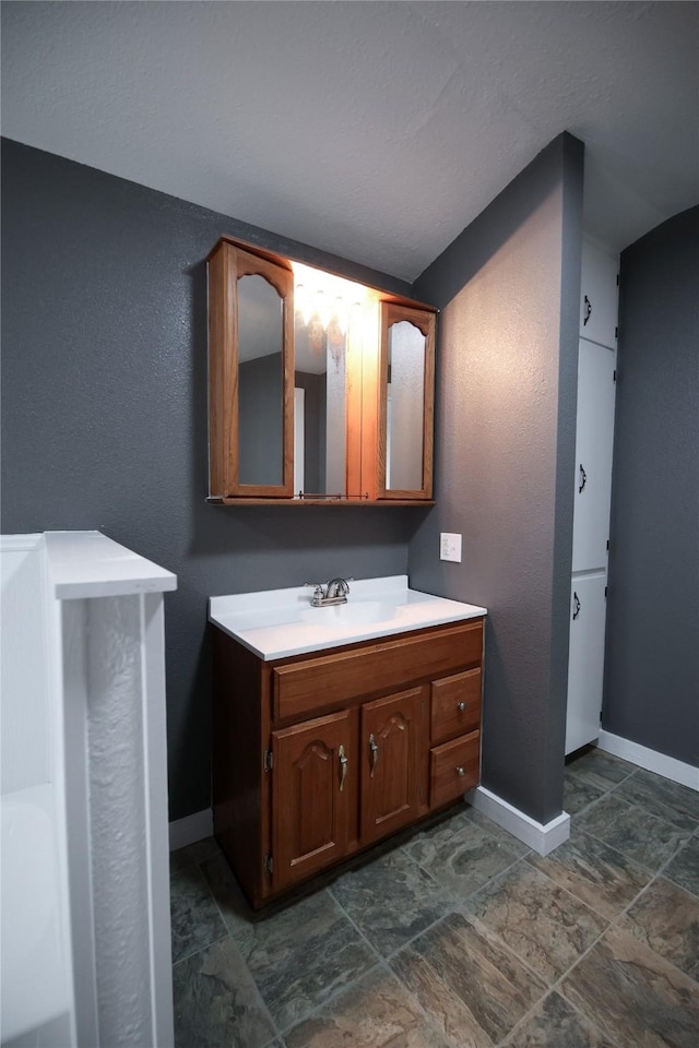 bathroom with vanity and baseboards