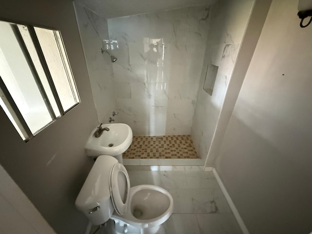 bathroom with toilet, a stall shower, baseboards, and marble finish floor