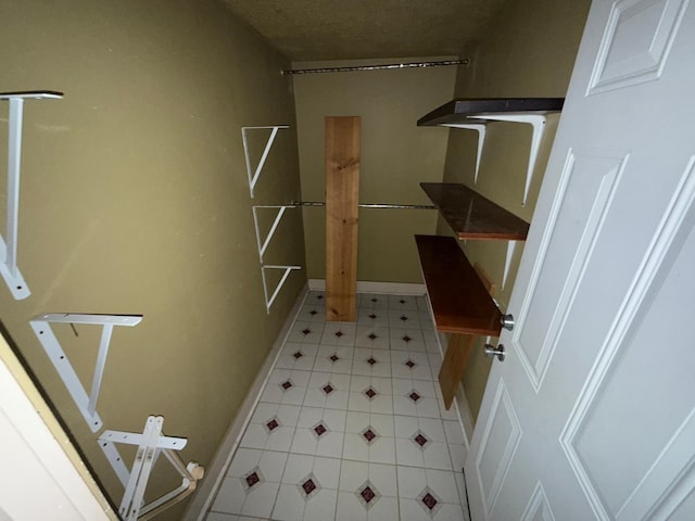 bathroom featuring tile patterned floors and baseboards