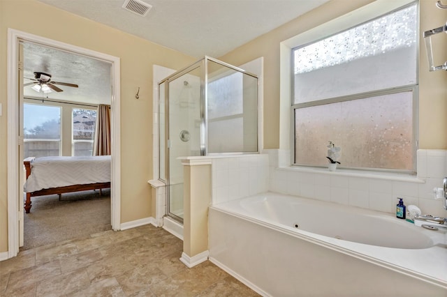 ensuite bathroom featuring ensuite bathroom, a textured ceiling, visible vents, a shower stall, and a bath