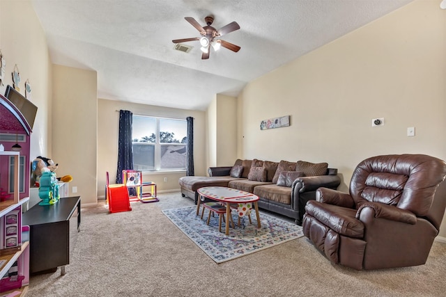 carpeted living room featuring baseboards, visible vents, a ceiling fan, vaulted ceiling, and a textured ceiling