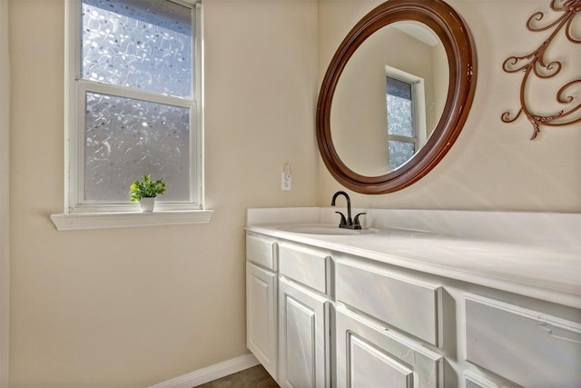 bathroom featuring baseboards and vanity