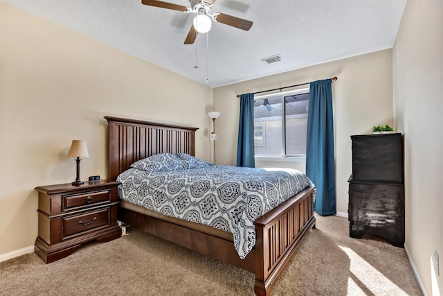 bedroom featuring baseboards, a ceiling fan, visible vents, and light colored carpet