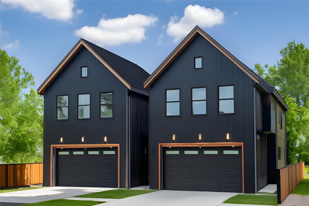 modern farmhouse style home featuring board and batten siding, fence, and an attached garage