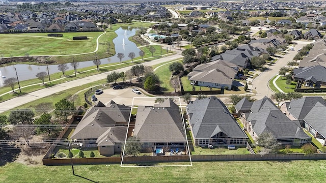 birds eye view of property with a water view and a residential view