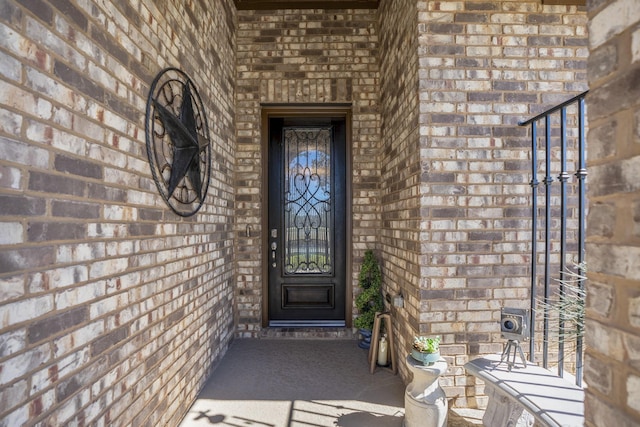 property entrance featuring brick siding