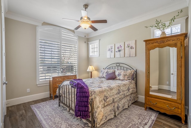 bedroom featuring ornamental molding, dark wood-type flooring, baseboards, and a ceiling fan