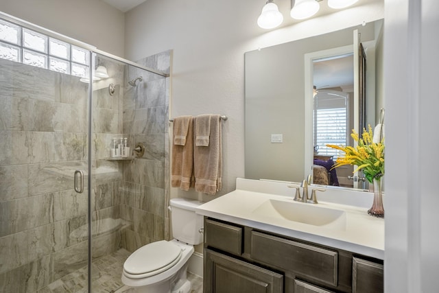 full bathroom with toilet, a stall shower, plenty of natural light, and vanity