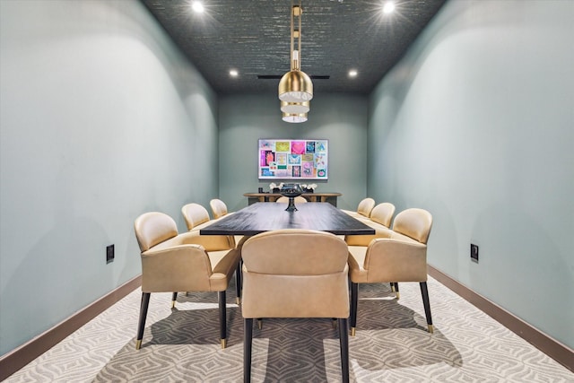 carpeted dining area with baseboards