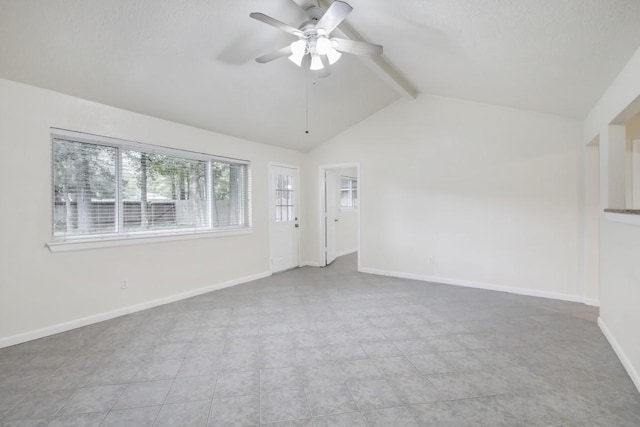 spare room featuring vaulted ceiling with beams, ceiling fan, and baseboards