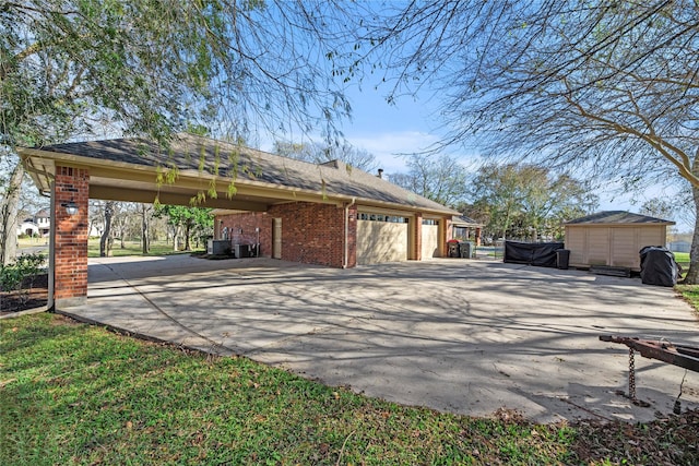 view of property exterior with a garage, brick siding, and driveway