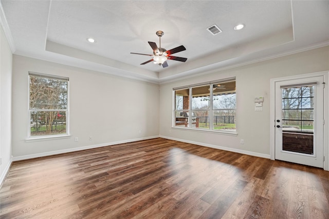 interior space featuring a raised ceiling, visible vents, and plenty of natural light