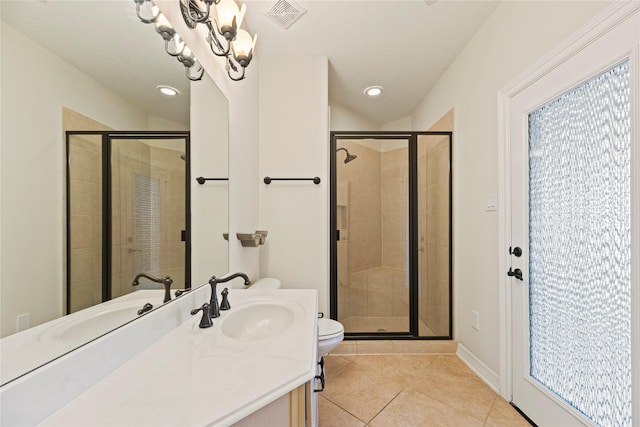 bathroom featuring visible vents, a shower stall, vanity, and tile patterned floors