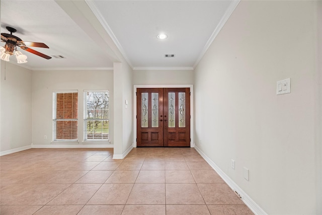 foyer entrance featuring light tile patterned floors, baseboards, visible vents, ceiling fan, and ornamental molding