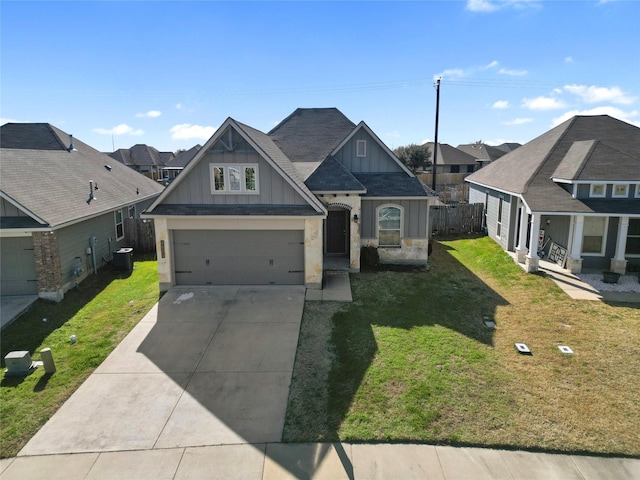 craftsman-style house with driveway, a garage, a residential view, a front lawn, and board and batten siding