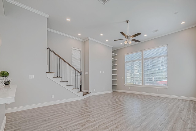 unfurnished room with ceiling fan, built in features, baseboards, ornamental molding, and light wood-type flooring