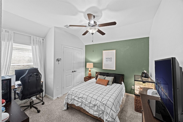 carpeted bedroom with vaulted ceiling, a closet, visible vents, and baseboards