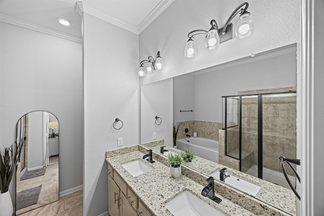 bathroom featuring crown molding, a stall shower, a garden tub, and a sink