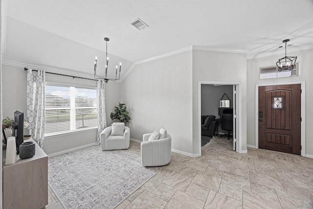 entrance foyer featuring a chandelier, ornamental molding, lofted ceiling, and visible vents