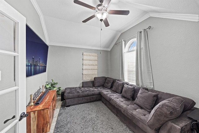 living area with vaulted ceiling, a textured wall, a ceiling fan, and crown molding