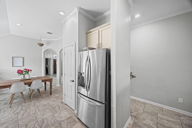 kitchen featuring arched walkways, stainless steel fridge with ice dispenser, visible vents, ornamental molding, and baseboards