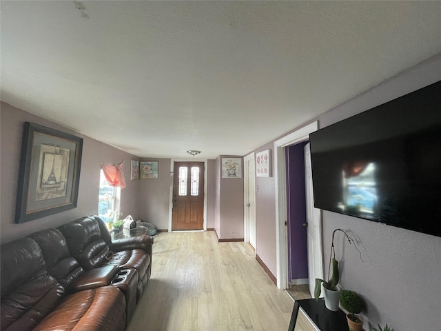 living room with light wood-style floors and baseboards