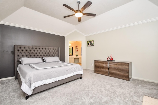 carpeted bedroom featuring lofted ceiling, connected bathroom, a ceiling fan, baseboards, and ornamental molding