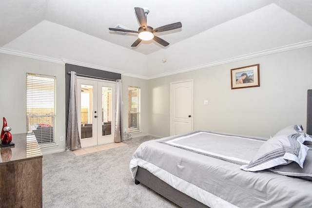 bedroom featuring light carpet, multiple windows, a raised ceiling, and french doors