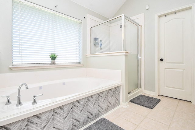 bathroom featuring lofted ceiling, a stall shower, tile patterned flooring, and a bath