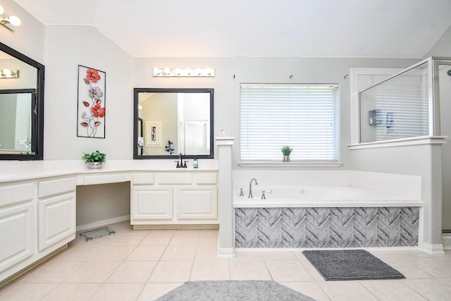 bathroom with vanity, vaulted ceiling, a shower, a bath, and tile patterned floors