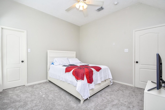 carpeted bedroom featuring lofted ceiling, ceiling fan, visible vents, and baseboards