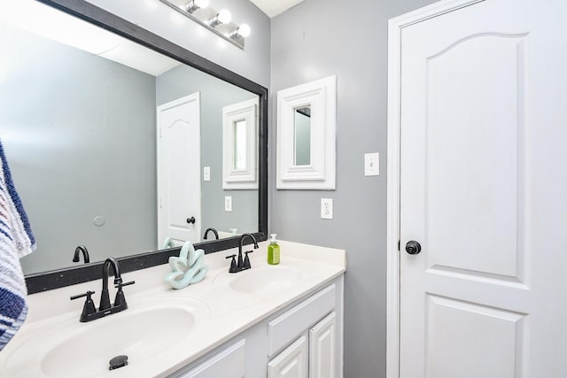 bathroom with a sink and double vanity