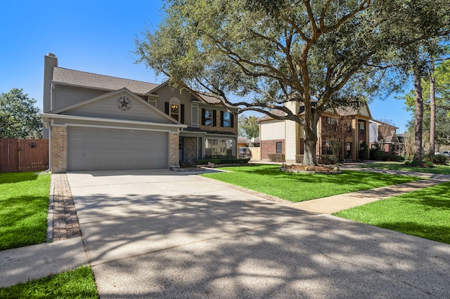 view of front of property with an attached garage, fence, concrete driveway, a chimney, and a front yard